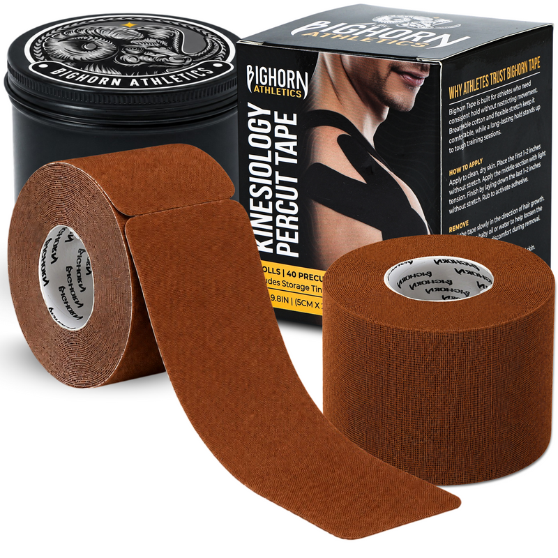 Brown bighorn Athletics kinesiology percutaneous tape shown with two rolls, one unrolled, a black storage tin, and the product box on a white background.
