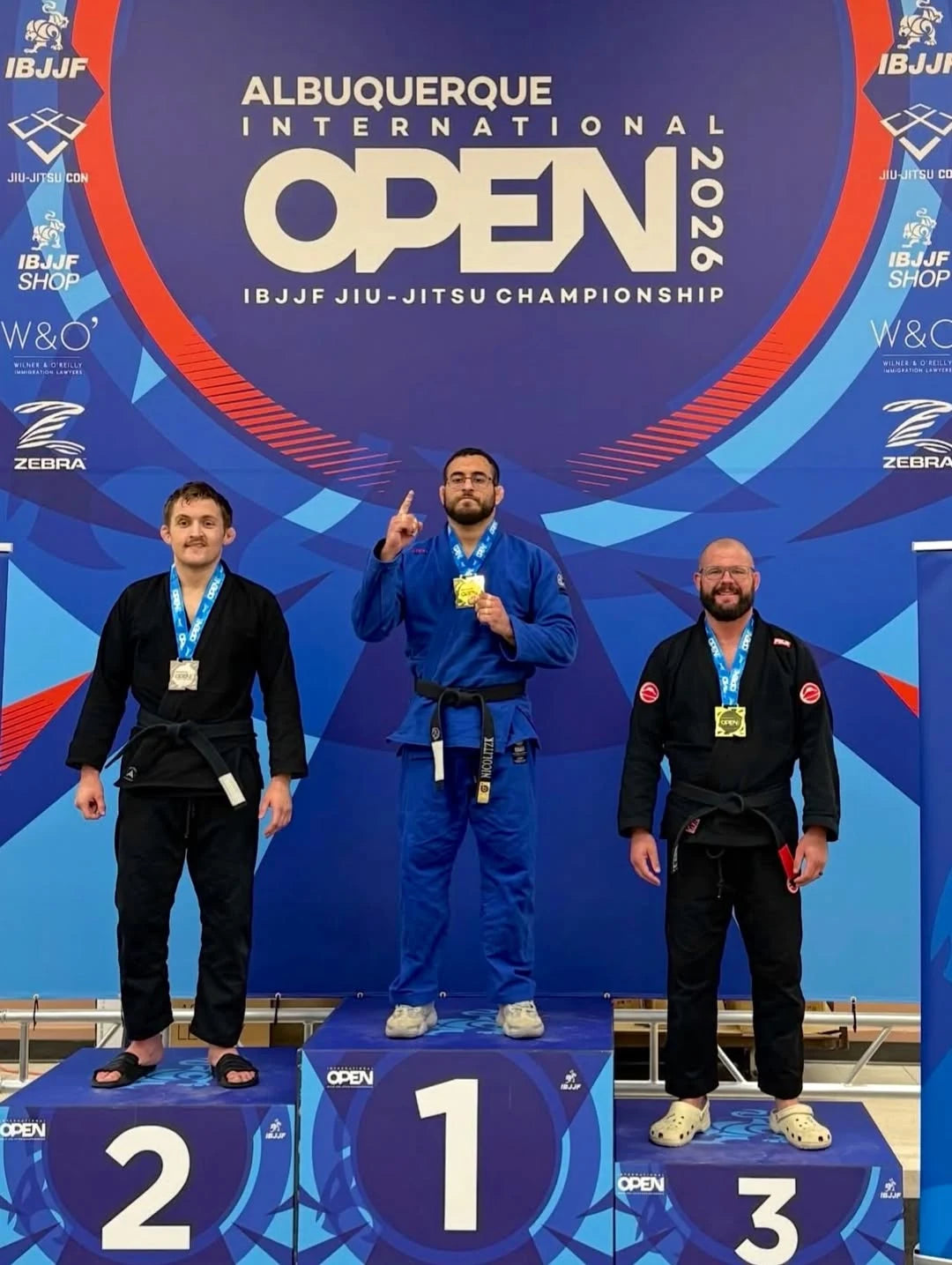 JOAO_PEDRO stand on a podium at the 2026 IBJJF Albuquerque International Open Jiu-Jitsu Championship. 