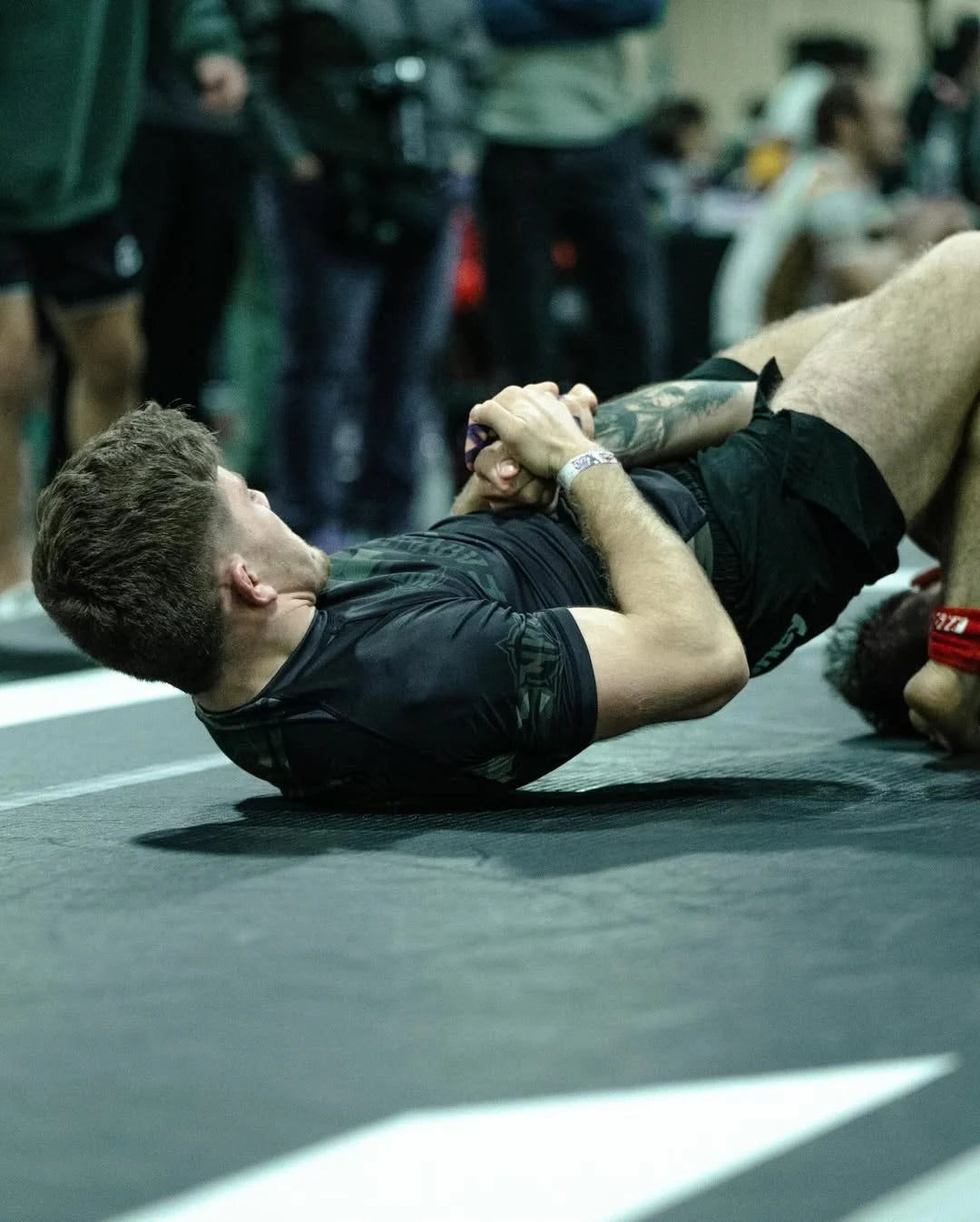 Joseph_Snyder on a dark mat in an indoor sports 