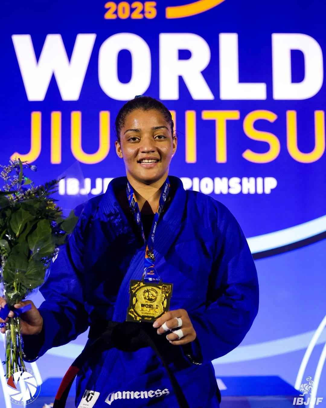 ARISSA_DIAS stands on a podium holding a gold medal